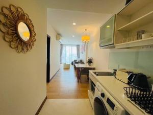 a kitchen with a counter and a dining room at The Astra Bozz Room in Chiang Mai