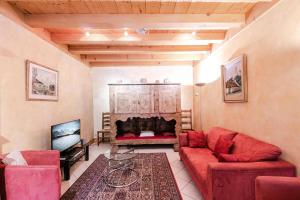 un soggiorno con divano rosso e camino di Résidence Perseverance - Chalets pour 12 Personnes 054 a Chamonix-Mont-Blanc