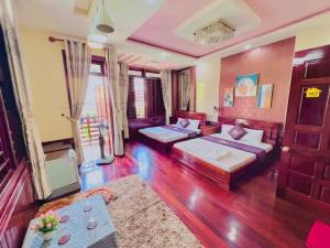a living room with two beds and a couch at canary homestay-We love having you here phòng lẻ in Hue