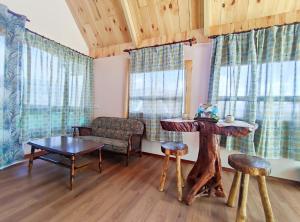 a living room with a couch and a table at Nulu View Cabin in Kampong Kundassan