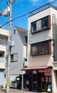 a building on the corner of a street at KOBE coffee hostel in Kobe