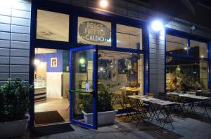 a store front of a restaurant with tables and chairs at B&B Pontemare in Ancona