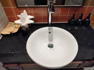 a white sink with a faucet in a bathroom at Apec Mandala Mui Ne Beach Studio in Ấp Thiẹn Ái +7 photos