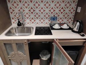 a kitchen counter with a sink and a stove at Apec Mandala Mui Ne Beach Studio in Ấp Thiẹn Ái