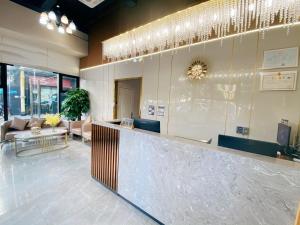 a lobby with a bar with chairs and a couch at Serveyou International Apartment - Free Airport Pickup Service & Free Pazhou Complex Shuttle Bus & Free Sanyuan Li Xiaobei Baiyun Wholesale Market shuttle bus in Guangzhou