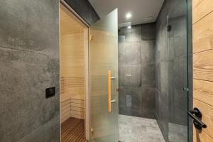 a shower with a glass door in a bathroom at Résidence Blom - Chalets pour 12 Personnes 634 in Saint-Martin-de-Belleville