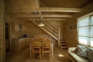 a kitchen and dining room with a table and chairs at Holiday Homes Eko Klanac in Rakovica