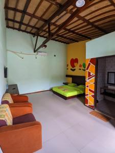 a living room with two beds and a fireplace at Mooipark Hotel Sorong in Sorong