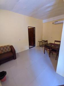 a living room with a couch and a table at Mooipark Hotel Sorong in Sorong