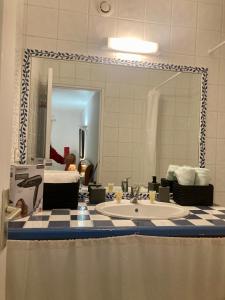a bathroom with a sink and a mirror at Mas de la pie in Saintes-Maries-de-la-Mer