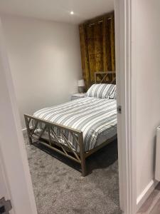 a bedroom with a bed in a room at Versace The Malt House in Burton upon Trent