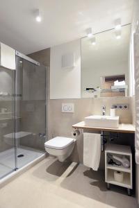 a bathroom with a toilet and a sink and a shower at Schlosshotel Ingelfingen in Ingelfingen