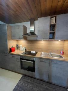 a kitchen with a stove and a sink at Sonnleitn 29 in Sonnenalpe Nassfeld