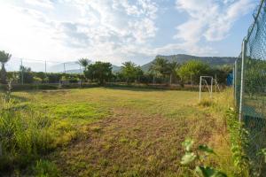 an empty soccer field behind a fence at ESTERIA PARK RESORT in Antalya