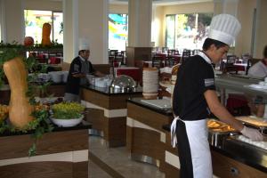 two chefs preparing food in a restaurant kitchen at ESTERIA PARK RESORT in Antalya