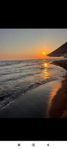 a sunset on a beach with the ocean at Ada Bojana - Kucica Djakonovic in Ulcinj