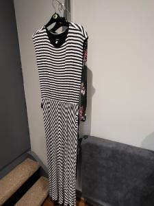a black and white striped dress hanging on a wall at Dragonflies in Hordle
