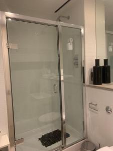 a shower with a glass door in a bathroom at Royal William Yard Studio FREE PARKING & WiFi in Plymouth