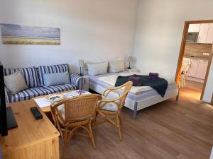 a living room with a couch and a living room with at Huus Südwest-Hörn in Norderney