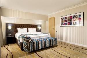a hotel room with a large bed in it at Shymkent Grand Hotel in Shymkent +32 photos