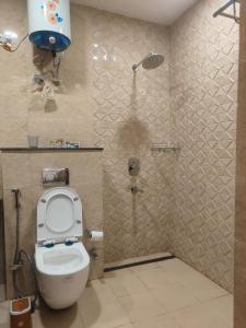 a bathroom with a shower with a toilet and a shower at Villa in Vrindavan, Hare Krishna M (ISKCON) campus in Vrindāvan