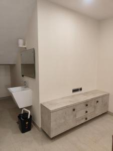 a bathroom with a sink and a wooden cabinet at Villa in Vrindavan, Hare Krishna M (ISKCON) campus in Vrindāvan