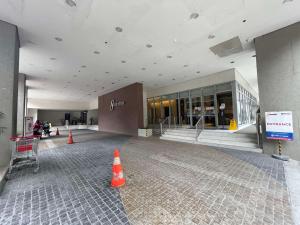 a large building with orange cones in front of it at Condo in Ermita near UP-PGH, St Lukes & US Embassy in Manila