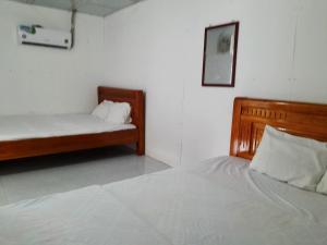 Postel nebo postele na pokoji v ubytování Homestay Nguyễn Hùng