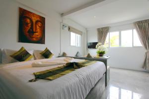 Postel nebo postele na pokoji v ubytování Samui Beach Residence Hotel