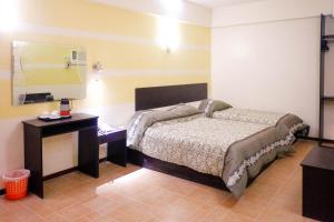 Postel nebo postele na pokoji v ubytování Metro Park Hotel Mandaue