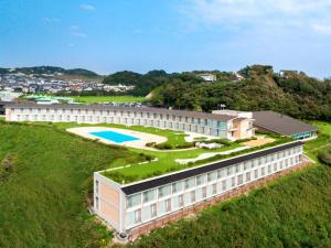 a large building with a garden and a swimming pool at Kamakura Prince Hotel in Kamakura