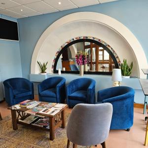 a waiting room with blue chairs and a table at La Playa Hotel in Marsalforn