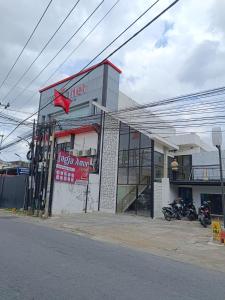 a store with motorcycles parked in front of it at Jogja Amor Hotel in Demangan