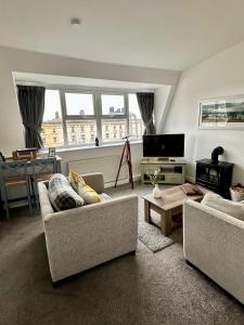 a living room with two couches and a tv at The Lookout, Bridlington in Bridlington