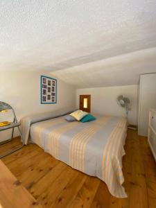 a bedroom with a bed and a fan at Residence Porto Coda Cavallo in San Teodoro