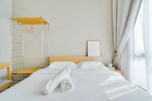 a white bed in a room with a window at The Horizon Ipoh in Ipoh