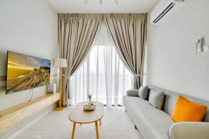 a living room with a couch and a table at The Horizon Ipoh in Ipoh