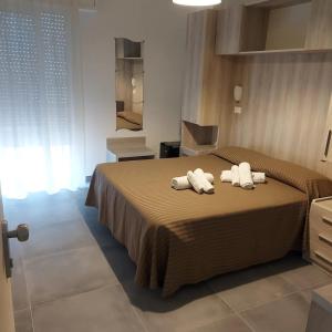 a bedroom with a bed with two towels on it at Hotel Concorde in Bellaria-Igea Marina