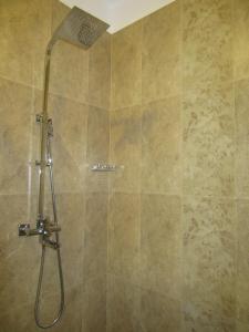 a shower with a shower head in a bathroom at Miridiya Resort in Yatiyantota