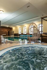 a swimming pool with a swing in a hotel room at Koncha Zaspa Park by HeyDay in Kozin