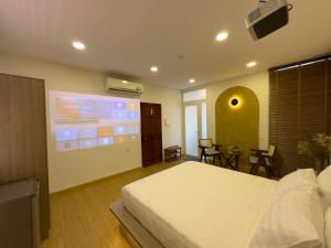 a bedroom with a large screen in a room at AIRIE LIVING in Ho Chi Minh City