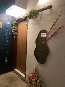 a guitar hanging on a wall next to a door at Two Sip Home in George Town