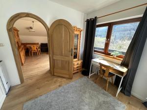 a room with a wooden door and a table at Piano Annaberg Apartments in Annaberg