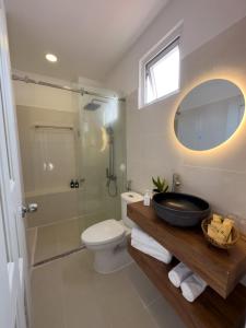 a bathroom with a sink and a shower and a toilet at AIRIE LIVING in Ho Chi Minh City