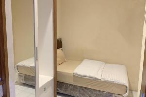 Postel nebo postele na pokoji v ubytování Residence 21 Syariah