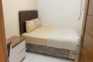 Postel nebo postele na pokoji v ubytování Residence 21 Syariah