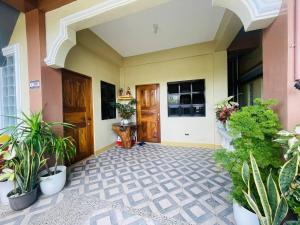 a hallway of a house with potted plants at Cozy 1BR Unit with Full Bathroom,Kitchen, Wifi at Sonia's Island Stay in Virac