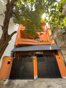 an orange building with two sets of doors at AIRIE LIVING in Ho Chi Minh City