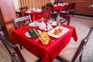 a table with red table cloth and food on it at LIMEWOOD HOTEL in Port Harcourt