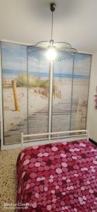 a bedroom with a large window with a view of the beach at Maison de village, au calme. in Camps-la-Source